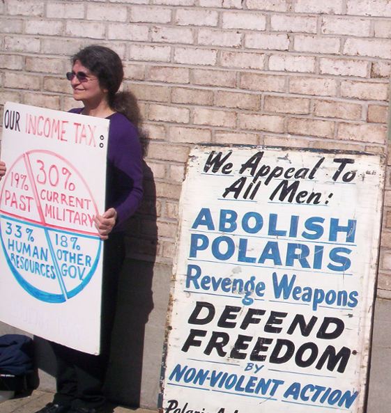 Left, DeCourcy; right, vintage 1960 Polaris Action sign, rescued from barn fire.